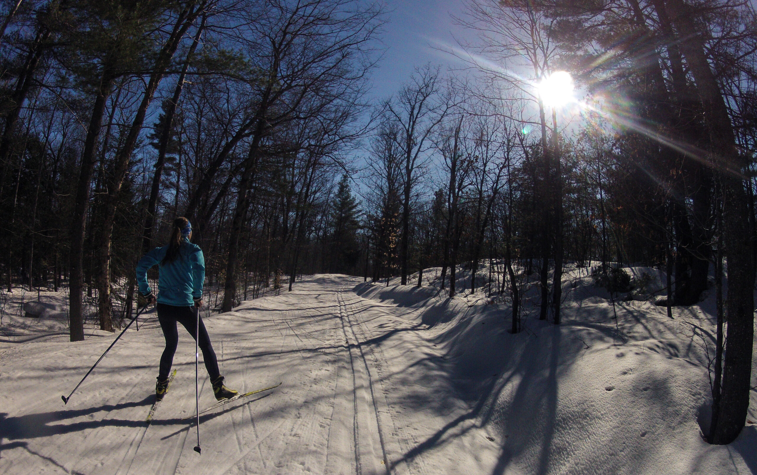 Skate skiing along the trail on a bright winter day. Photo credit: Peter Istvan